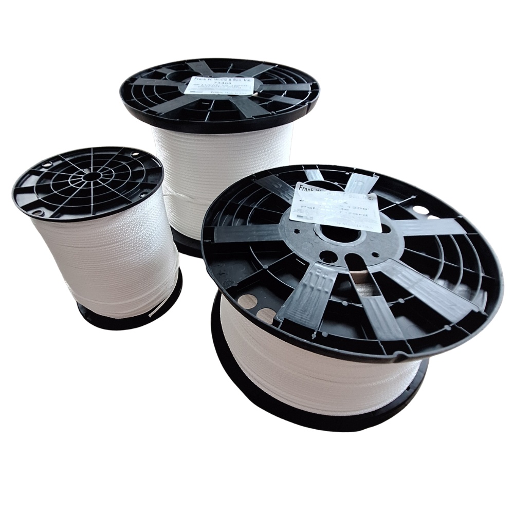Three spools of white rope with black reels on a white background